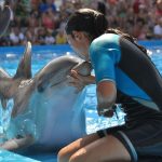 Instructor kisses dolphin at Marineland Majorca