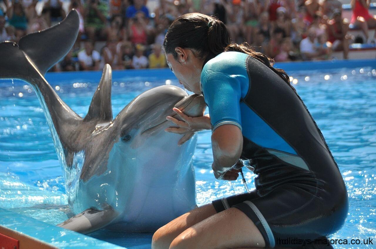 Instructor kisses dolphin at Marineland Majorca