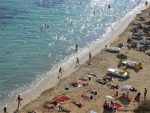 People play and sunbathing on the beach at Puerto Portals Majorca