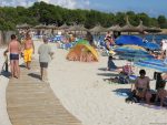 Beach walkway and bathers in Sa Coma Majorca