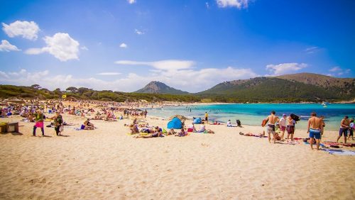 People sunbathing on Cala Ratjada beach