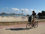 Man riding a bike on the Sa Coma promenade Majorca