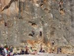 People climbing the cliffs at Cala Bota beach Majorca
