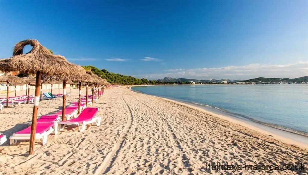 Alcudia across the beach with sun loungers and shades