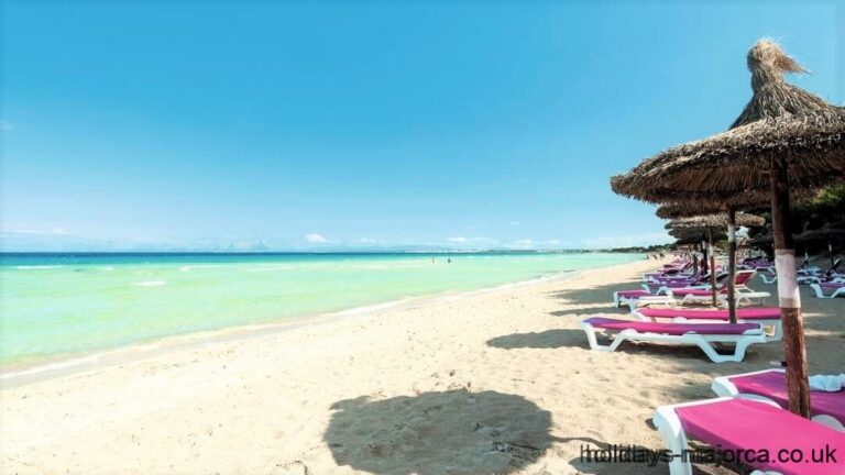 Alcudia beach with sun loungers and shades Majorca