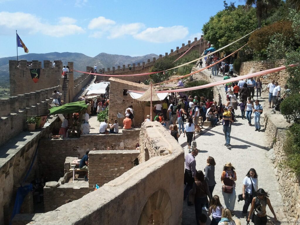 People within the Capdepera fortress wall during the medieval market Majorca