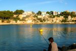 Boy shore fishing Majorca